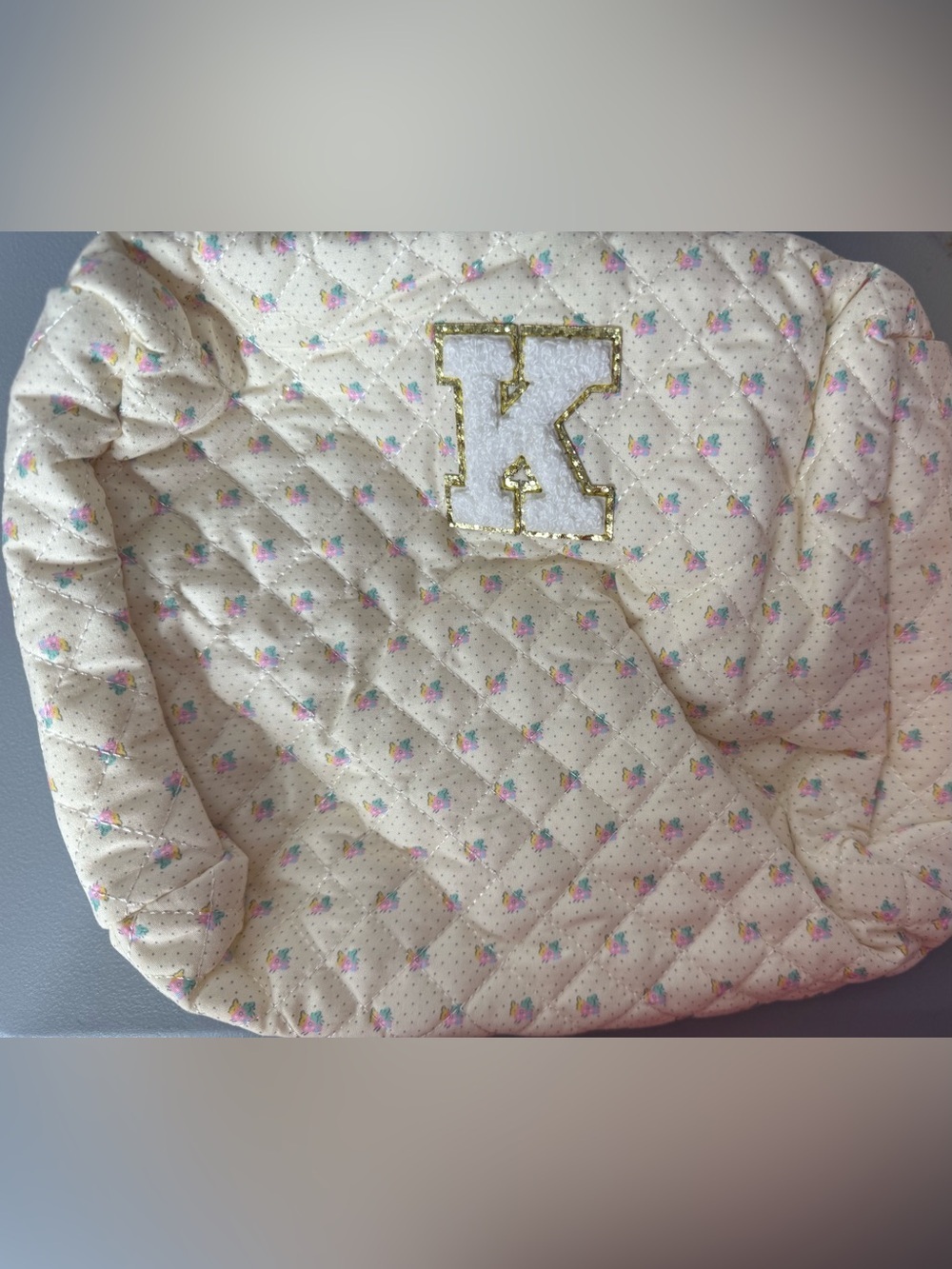 Cream Quilted Cosmetic Pouch with Gold-Trimmed 'K' Appliqué monogram zipper